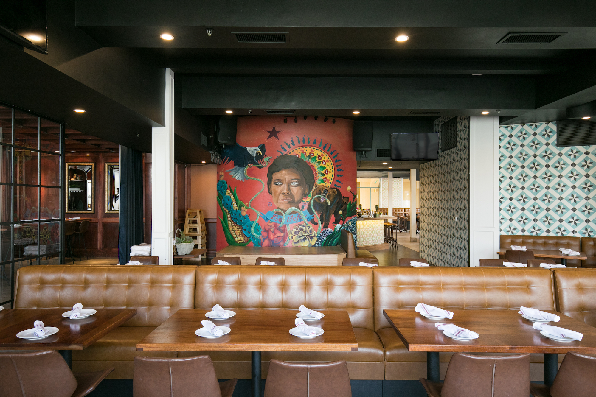 Dining area of restaurant with mural in the background